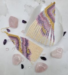 the beaded earrings are next to some rocks