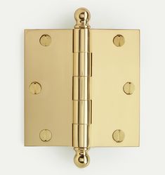 a brass plated door hinge with four holes