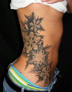 a woman's lower back with snowflakes on it