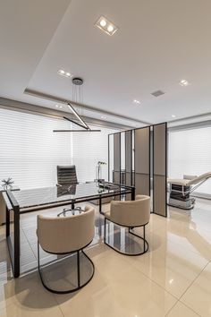 an office with two chairs and a glass table in the middle, along with other furniture