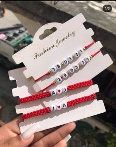 three red and white beaded name bracelets