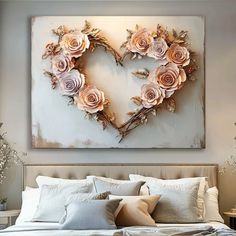 a large heart shaped painting on the wall above a bed with pillows and throw pillows