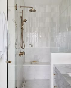 a walk in shower sitting next to a white bath tub under a faucet