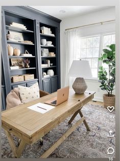 a living room filled with furniture and a laptop computer on top of a wooden table