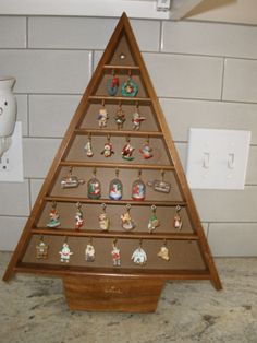 a wooden christmas tree with ornaments on it