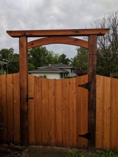 a wooden gate with an arch over it