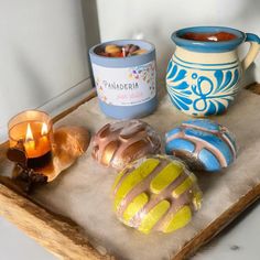 there is a tray with donuts, candles and a candle holder on it that says panaderia