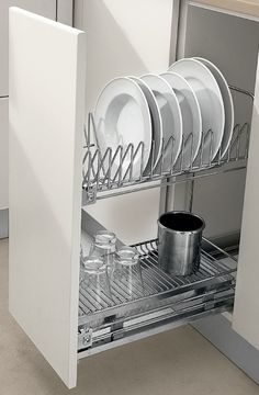 an open dish rack in a kitchen with dishes and utensils on the bottom shelf