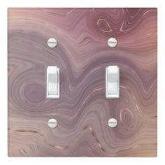 two light switch plates with marble design on each one and an outlet in the middle