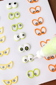 an orange and green marker is being used to make eyeballs for the craftivity project