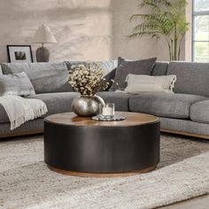 This stylish and functional coffee table is a true multi-functional MVP. It doubles as a spot to kick up your feet after a long day or place down some snacks for movie night. The round frame is crafted from solid pine wood with a solid hue, while the surface showcases a natural brown hue with a rugged, starburst motif that's sure to complement a variety of aesthetics from boho to coastal. And the surface sets the stage for a stack of coffee table books or a vase of fresh flowers. But the best pa Functional Coffee Table, Coffee Table Black, Sofa End Tables, Solid Wood Coffee Table, Classic Home, Wood Coffee Table, Table Books, Table Black, Farmhouse Country