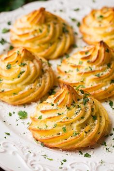 potato chips on a white plate with parsley