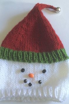 a knitted snowman hat on top of a white table