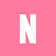 the letter n is made up of white paper on a pink background with a shadow