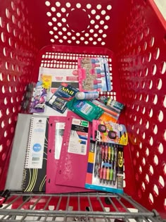 a red shopping cart filled with school supplies