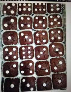 chocolate cupcakes with white polka dots in a box