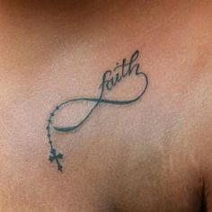 a woman's chest with the word faith written in cursive writing on it