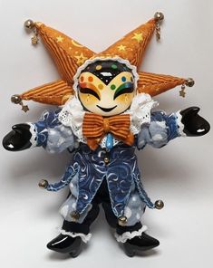 an orange and blue clown doll with stars on its head