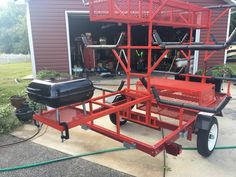 a red trailer with a cooler attached to it's back and two hoses connected to the cart