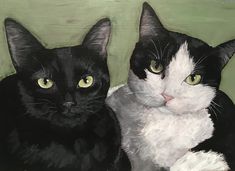 two black and white cats sitting next to each other on a green surface with yellow eyes