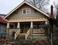 a small house with two porches and stairs