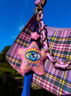 a pink purse with an evil eye on it