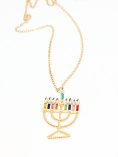 a necklace with a menorah pendant on it