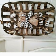 a basket filled with cotton balls on top of a white dresser next to a wall