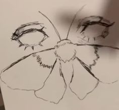 a drawing of a flower is shown on a piece of paper that has been drawn