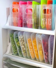 plastic containers filled with food and vegetables in a refrigerator