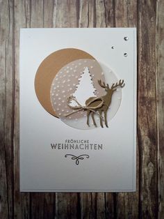 a christmas card with an ornament in the shape of a reindeer on it