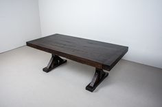 a wooden table sitting on top of a white floor