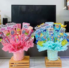 two vases filled with candy sitting on top of a counter next to each other