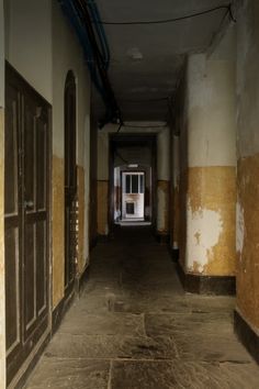 an empty hallway with doors and windows