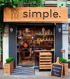 an image of a store front with plants growing out of the window and on the outside