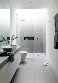 a bathroom with a sink, toilet and shower