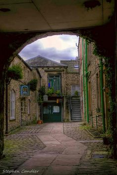 an alley way with stone buildings and steps leading up to the building on either side