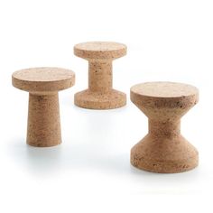 three small stools made out of cork on a white background