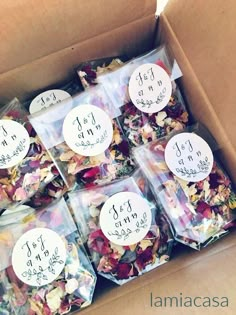 a cardboard box filled with lots of different types of dried flowers and labels on them