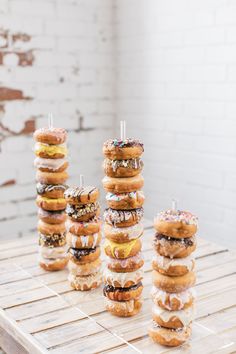 donuts stacked on top of each other with candles in them