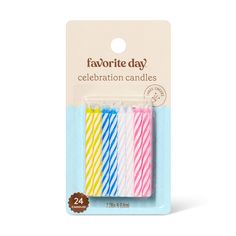 four different colored candles in a package