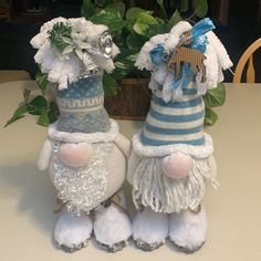 two small stuffed animals sitting on top of a table