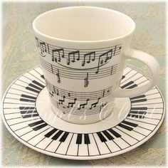 a cup and saucer with musical notes on it