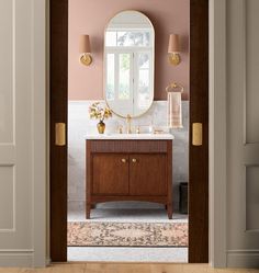 an open door leading to a bathroom with pink walls