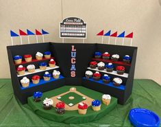 cupcakes are displayed in the shape of baseball stands