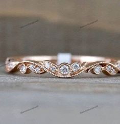 a rose gold wedding band with white diamonds