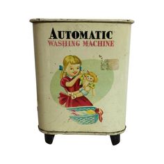 an old fashioned washing machine with a girl holding a doll