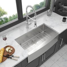 a stainless steel kitchen sink and cutting board