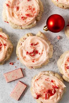 cookies with frosting and candy canes next to a red bauble ornament