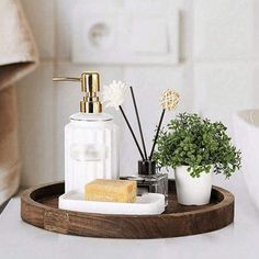 a bathroom tray with soap, toothbrushes and plants